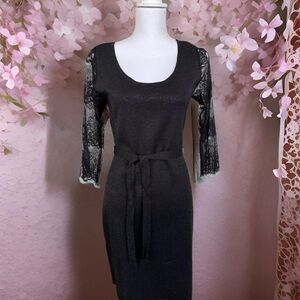 Carmen Marc Valvo black party dress with lace sleeves.